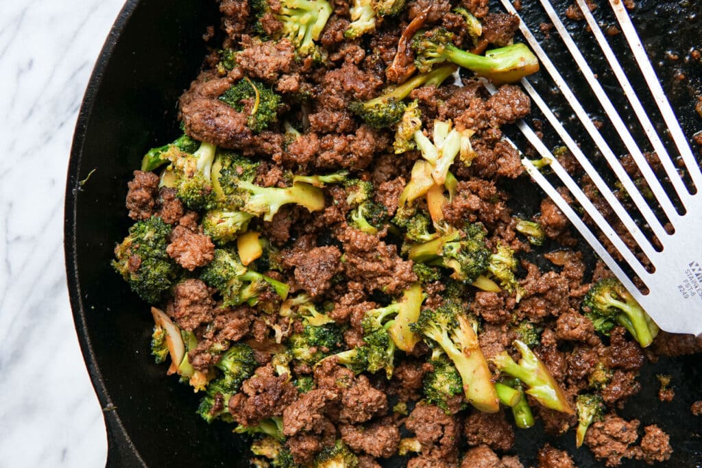 Spicy Sesame Beef + Veggie Bowls with Tangy Carrots in a cast iron