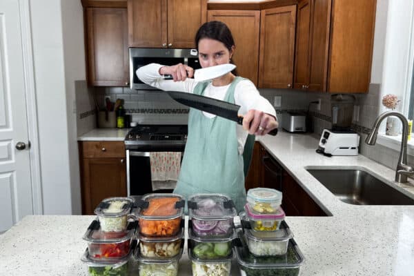 natalie showing several containers of prepped food