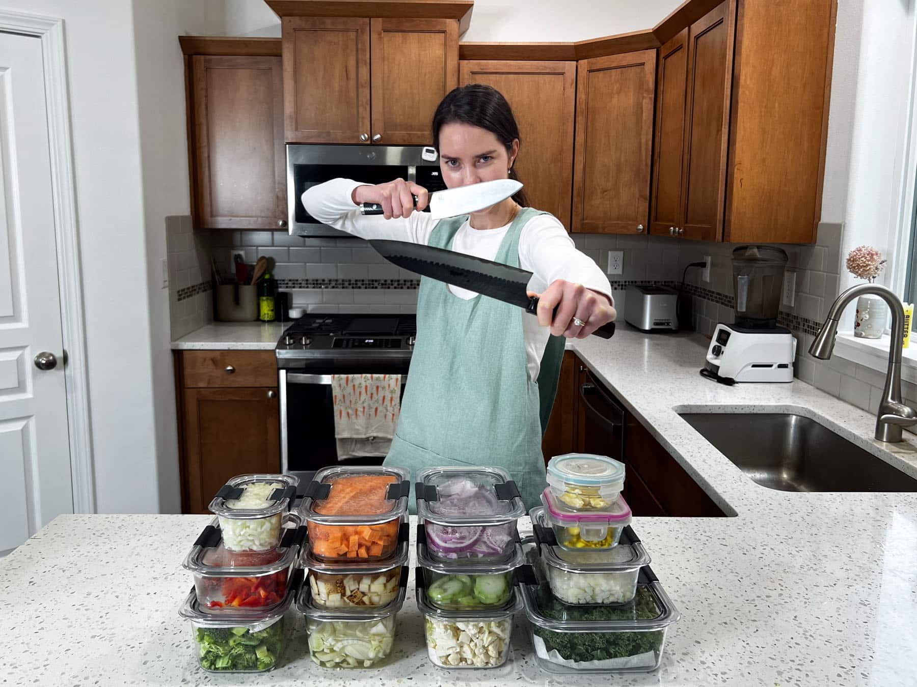 natalie showing several containers of prepped food